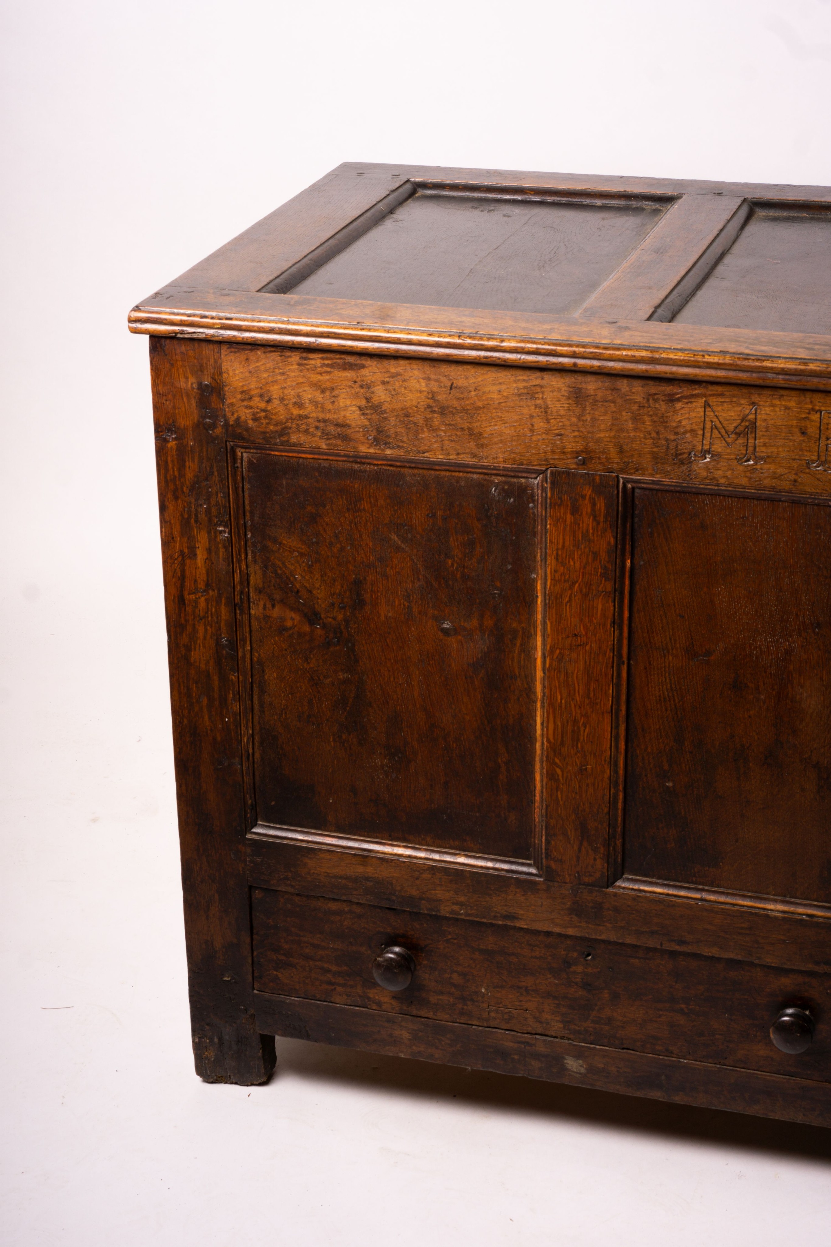 An 18th century panelled oak mule chest, length 161cm, depth 61cm, height 84cm